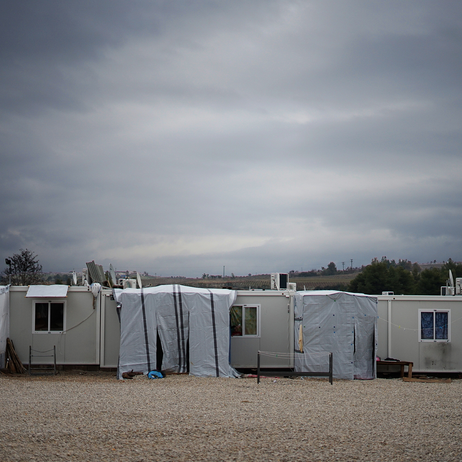 photograph of small, temporary housing units in a desolate area.